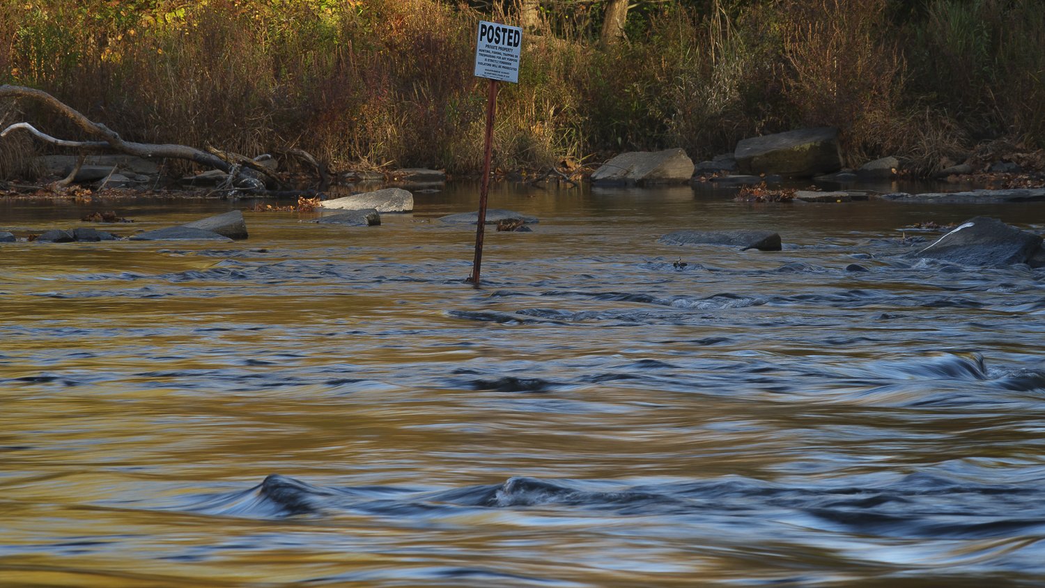  A no trespassing sign, as seen on the river, at the entrance to the Douglaston Salmon Run, which is owned by the Barclay Family.  It’s technically legal to take a boat through this section of the river, but if the boat touches a rock or the bottom a