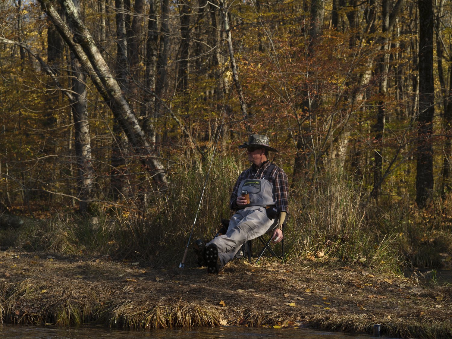  A fisherman takes a break and has a beverage on the Salmon River near Altmar, New York. Apart from trying to land a trophy catch, anglers can often be seen resting, napping, sipping, and enjoying makeshift outdoor lounges all along the riverside.   