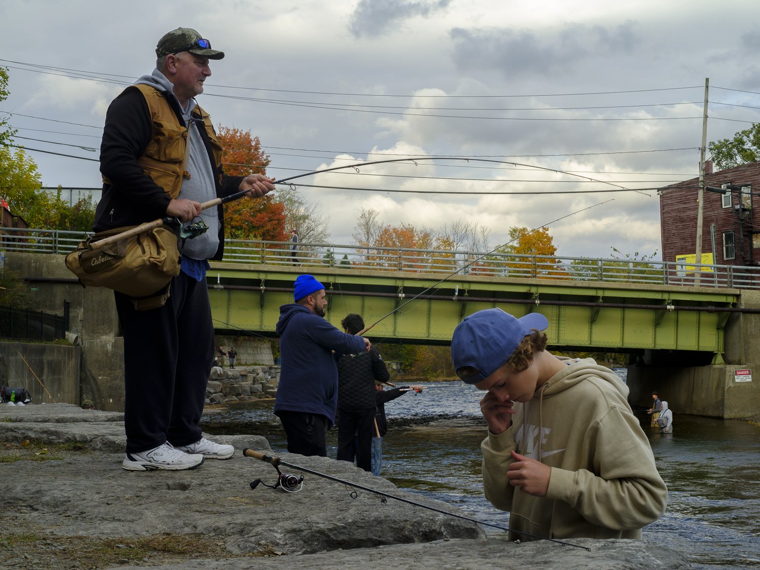  Alfred Hager, a truck driver from Buffalo, New York fishes with his family at a public access site on the Salmon River in Downtown Pulaski.  
