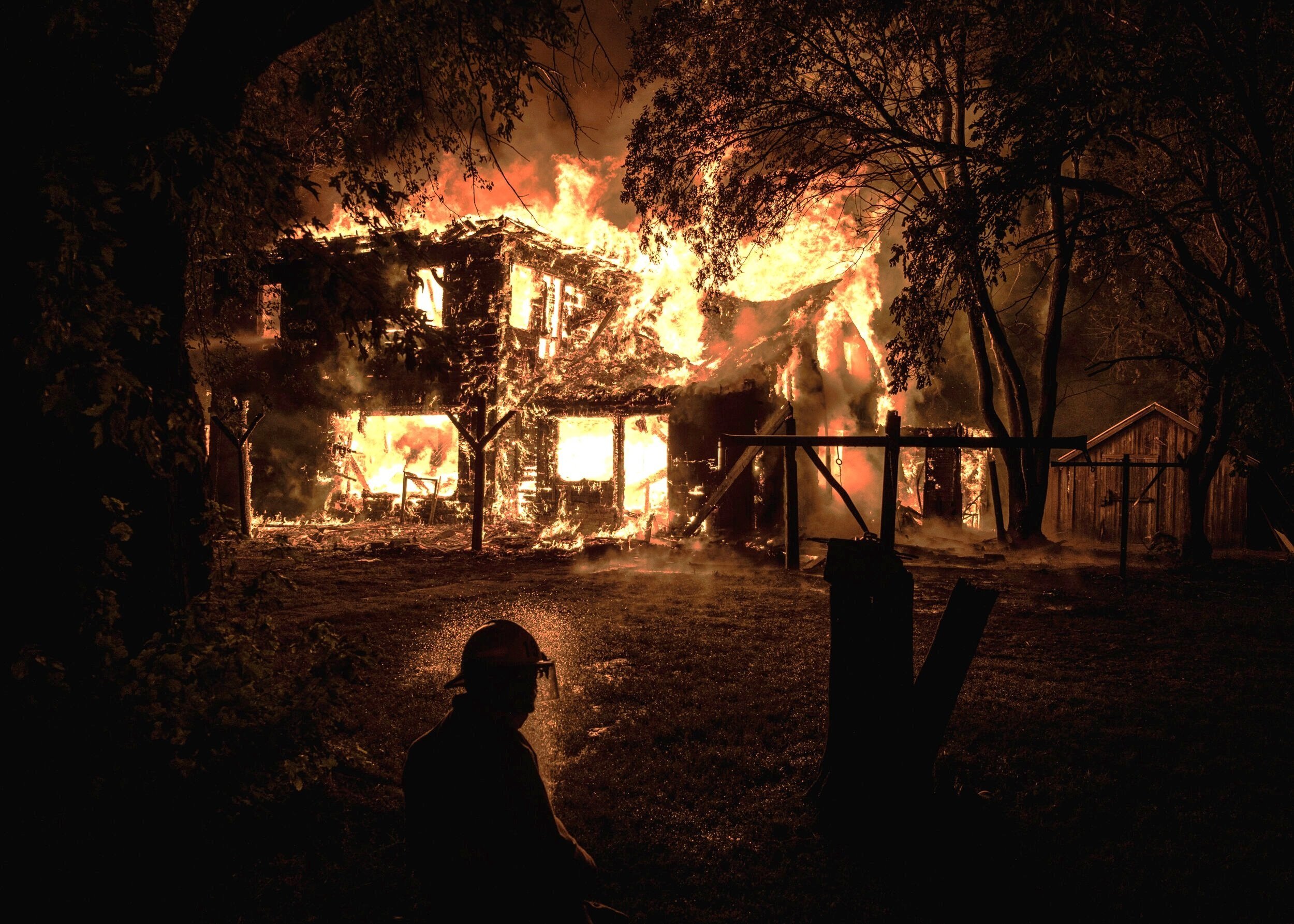  Local volunteer firefighters from multiple departments conduct a controlled burn on a farmhouse for training near Sheldon, Iowa on Thursday, Aug 15, 2019. Controlled training burns used to be much more common in the area until insurance and environm