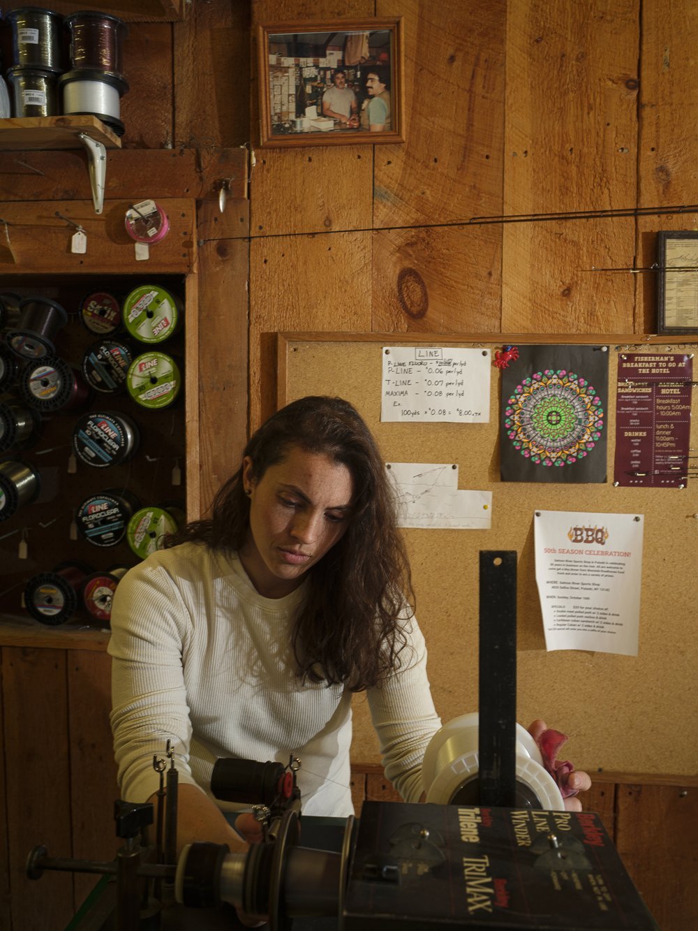  Zana Gervais stands for a portrait while spooling line in the Salmon River Sports Shop on Saturday, October 15, 2022. Zana is a third-generation store owner and bought the store from her family in 2020. She is an expert angler and is actively sought