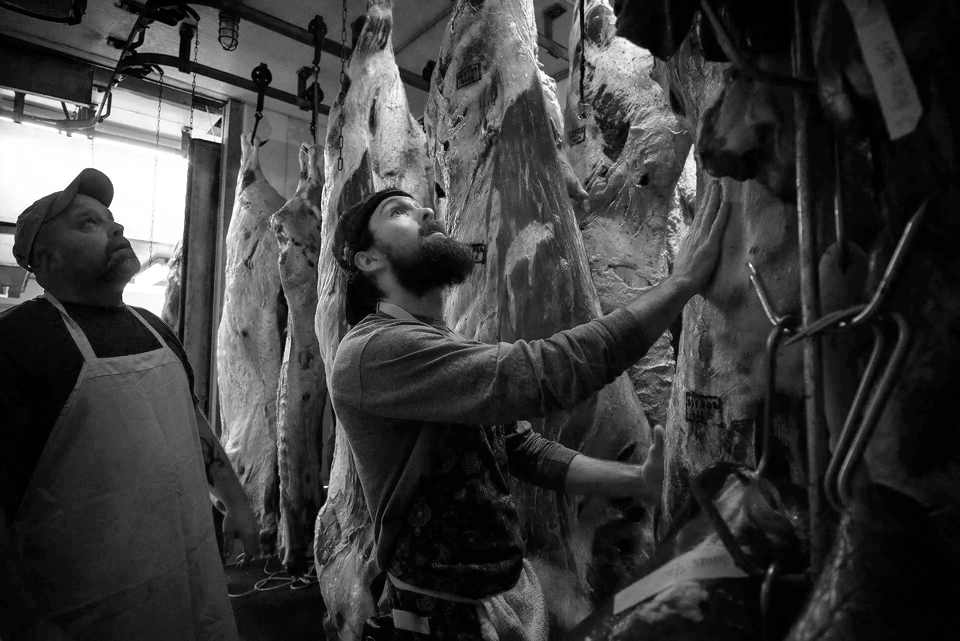  Joe Wood and Jesse Florence rearrange some beef to get to the order needed for processing at the Riverview Meat Company on Tuesday, May 25, 2021.   The Riverview Meat Company is Harrison County's only meatpacking establishment. The meatpacking indus