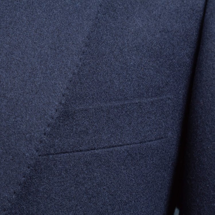 Lapel of a handmade suit and chest pocket with pick stitching  