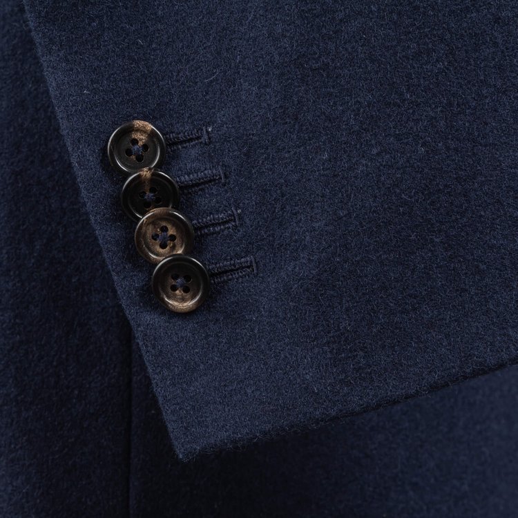 Marine+ 4 kissing buttons on a sleeve of a navy blue bespoke suit 