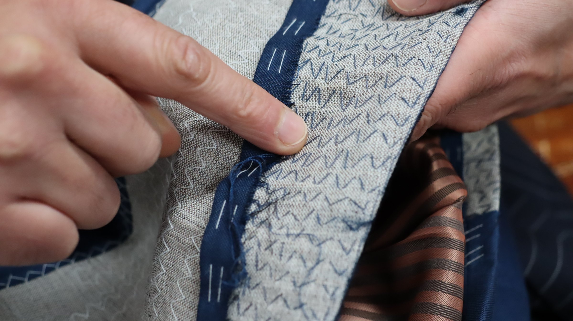 Irregular stitching is the sign of manual work.