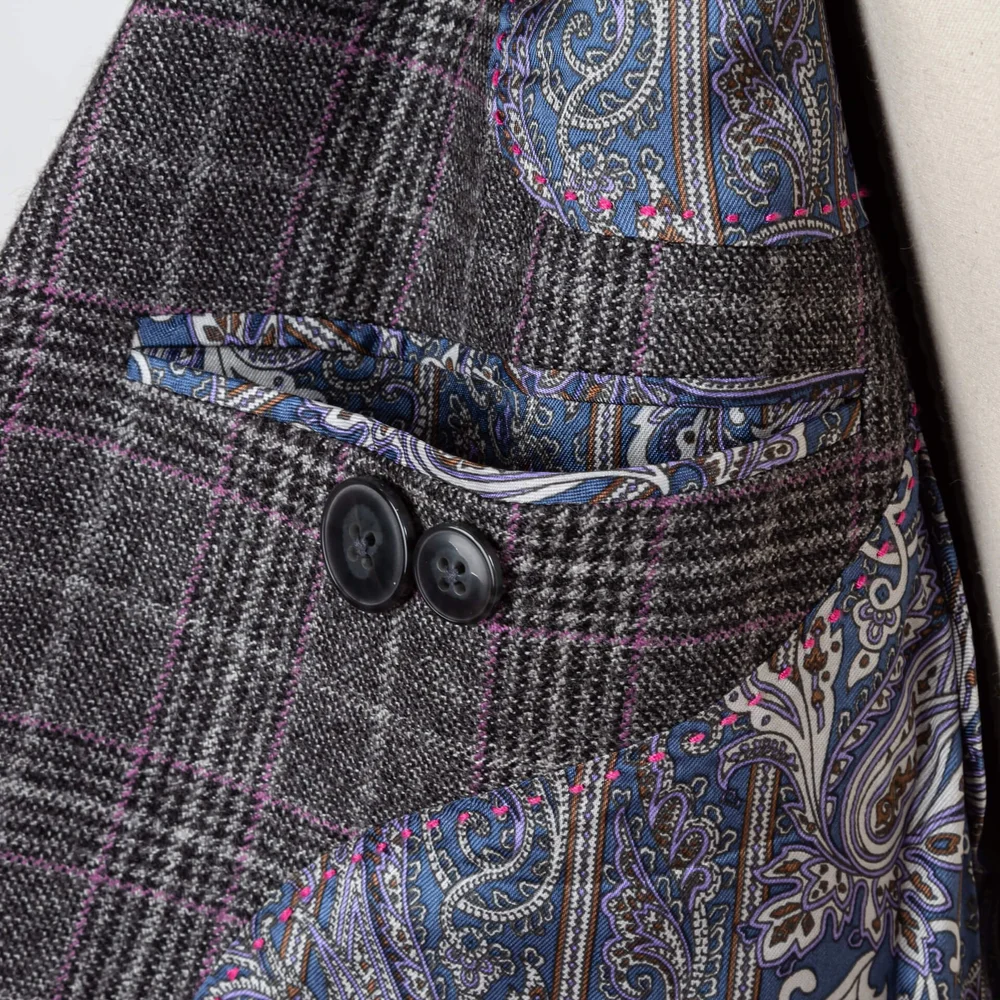 Close-up of paisley lining, purple pick stitching and inner pocket of bespoke jacket