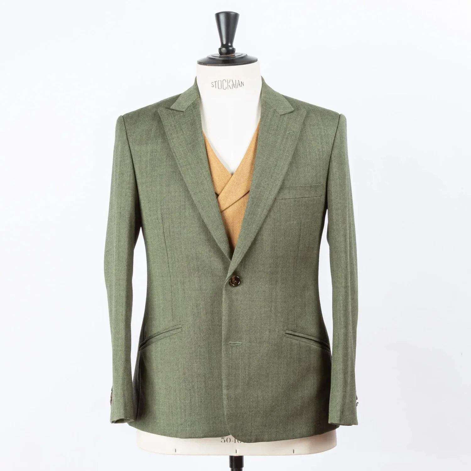 Sage green three-piece wedding suit with camel waistcoat