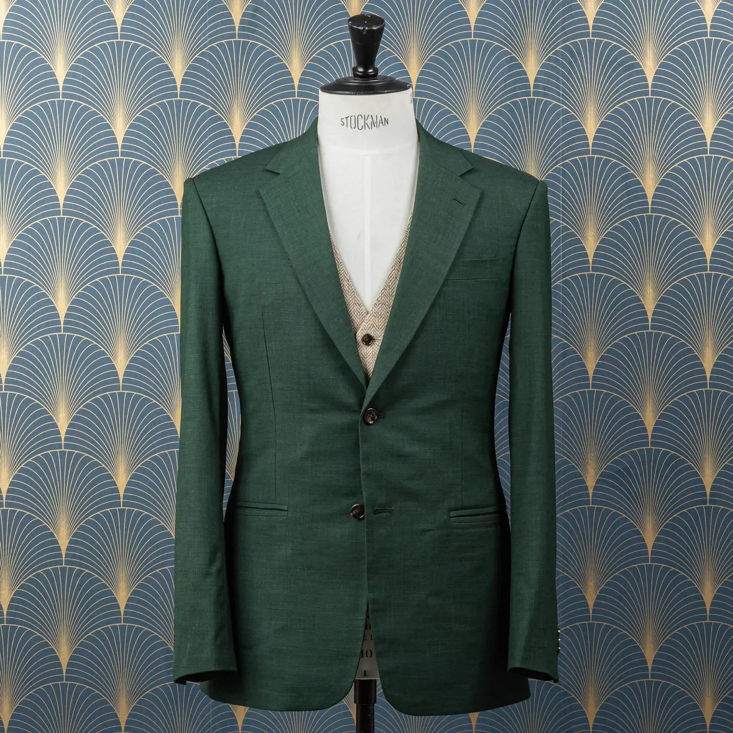 Green three-piece wedding suit with beige herringbone waistcoat