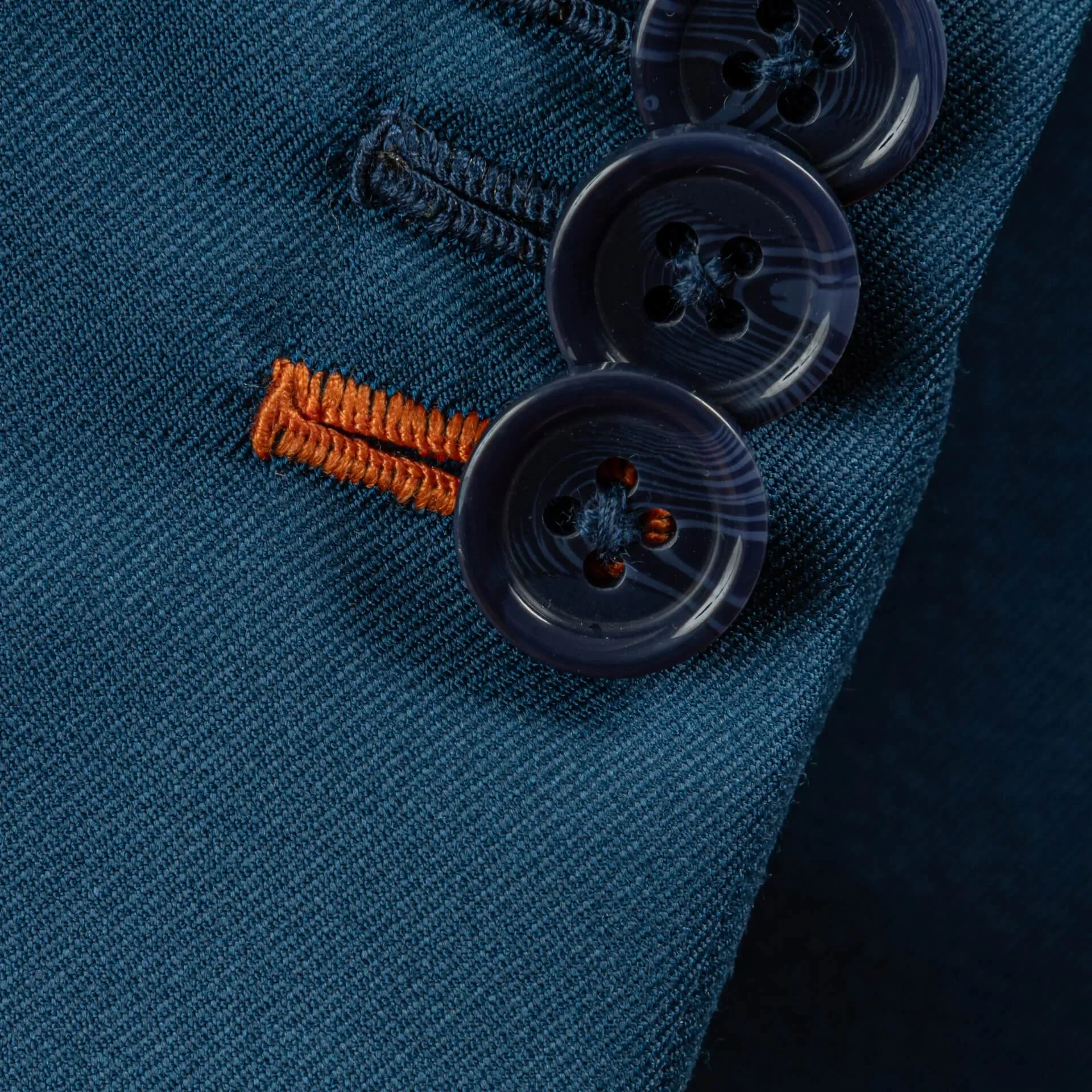Close-up orange buttonhole contrast detail bespoke jacket