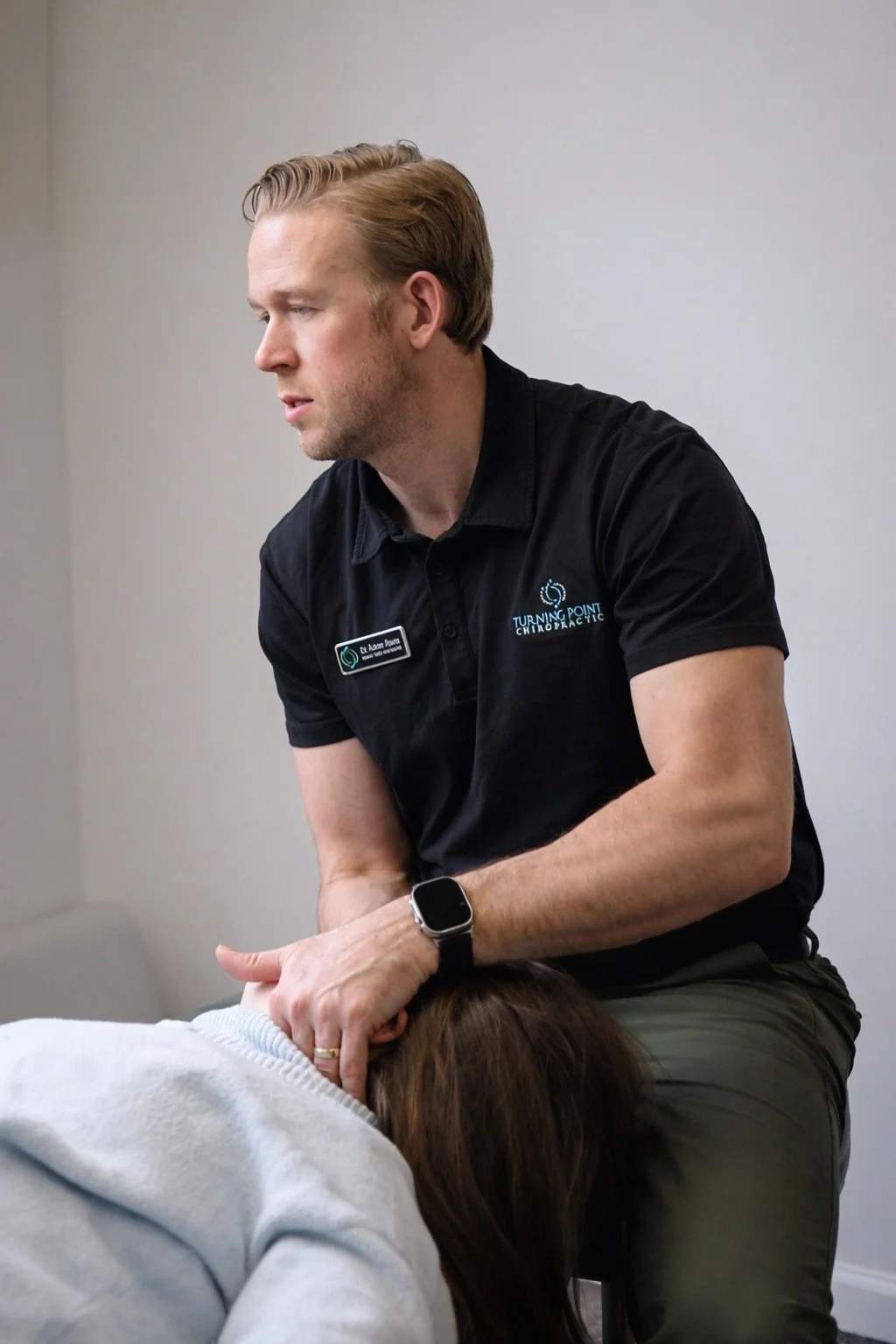 Chiropractor performing a neck adjustment