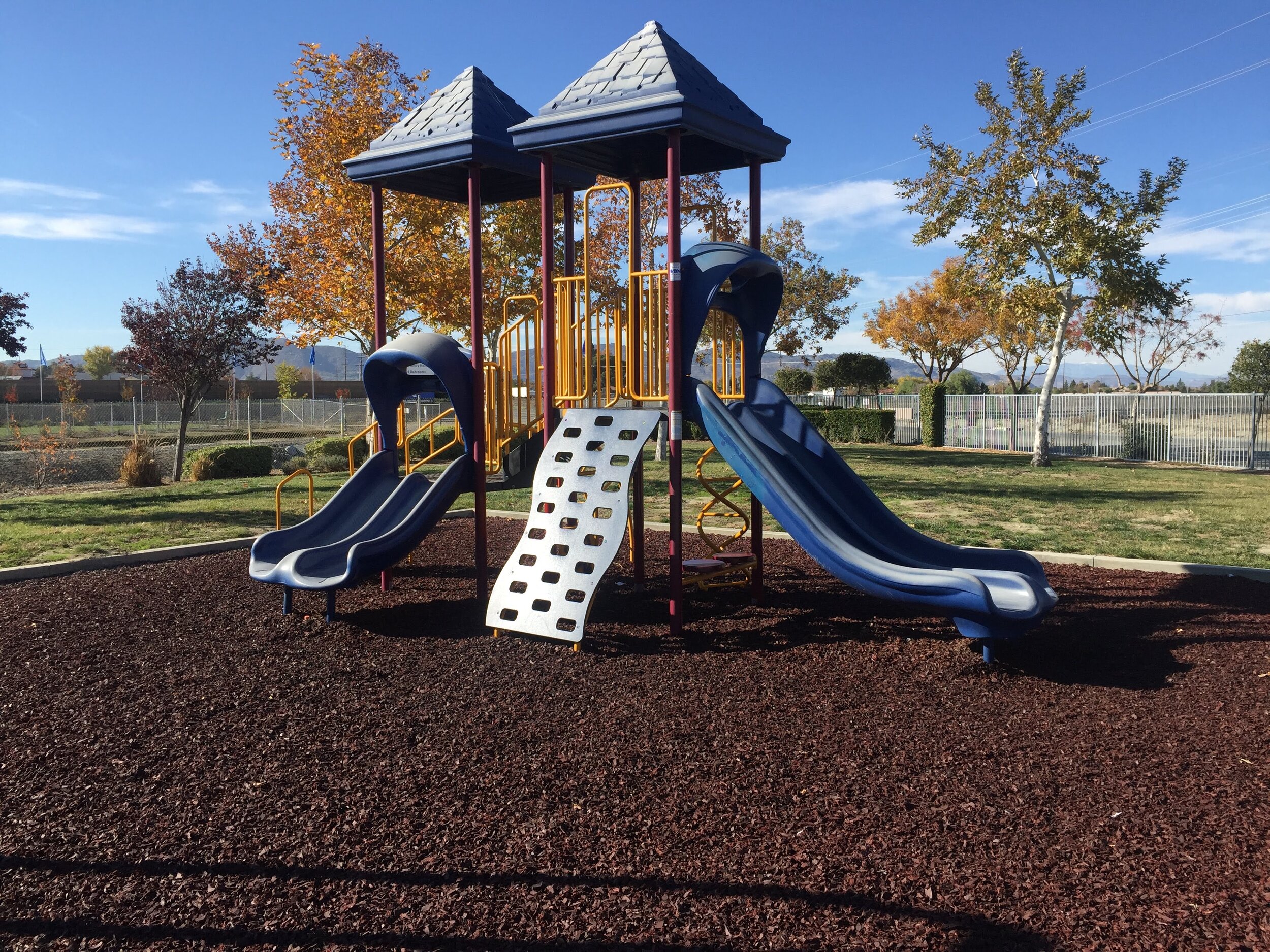 Inorganic mulches such as rubber mulch for a playground
