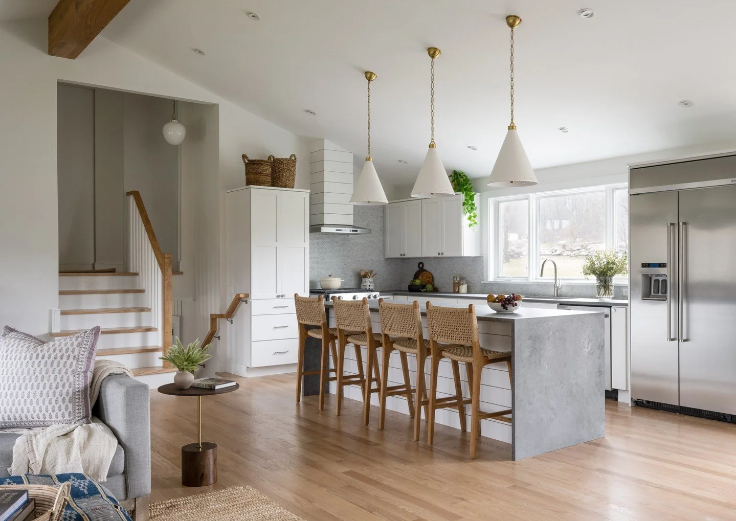 This split level ranch renovation reimagines the heart of the home with an open, light-filled floorplan that celebrates connection and simplicity. Natural materials, clean lines, and layered textures bring warmth to the modern updates &mdash; proof t