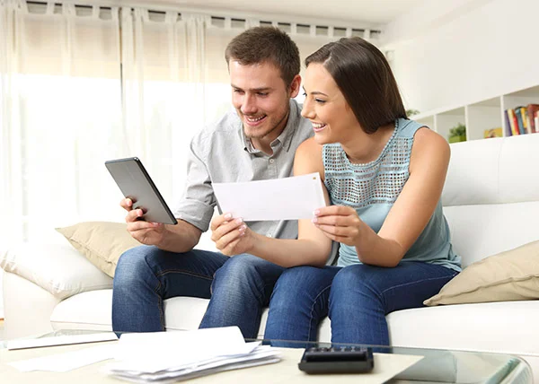 business couple depositing check on mobile device.jpg