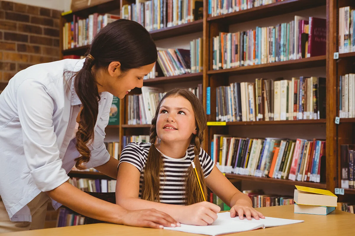 teacher helping student with school work.jpg