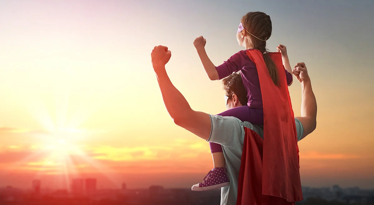 girl on dads shoulders dressed as superheros.jpg