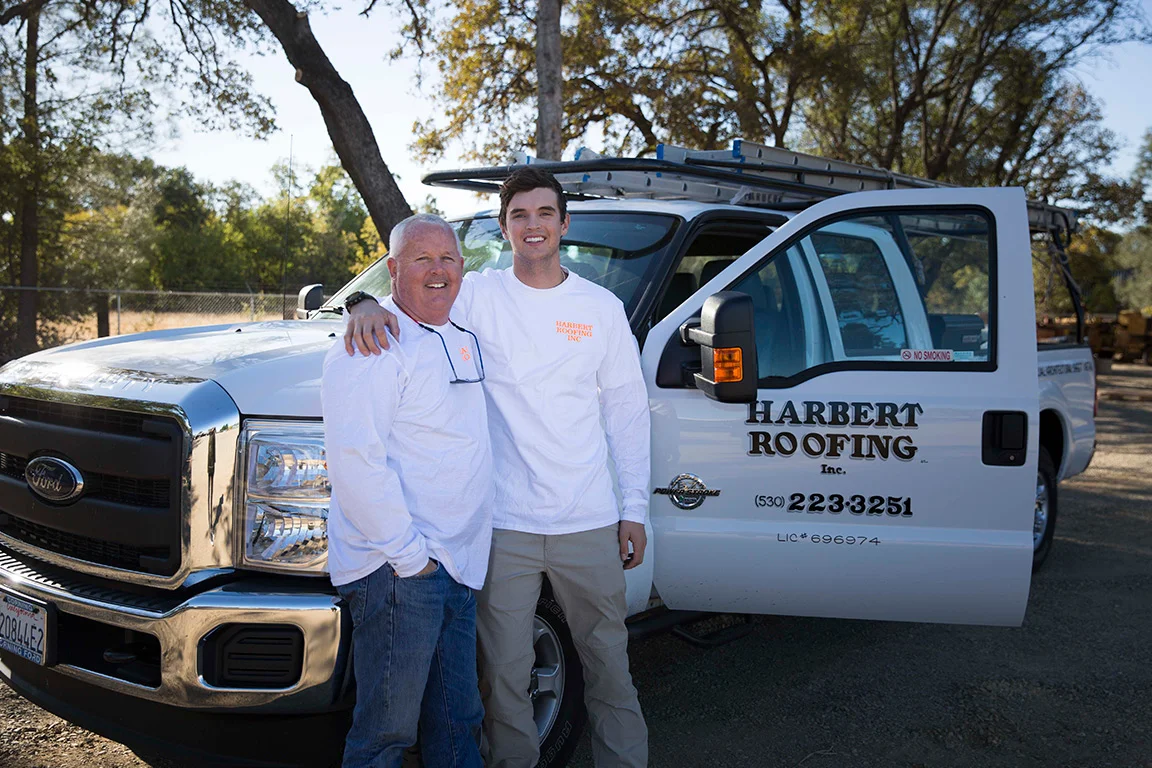 Roofers next to work truck