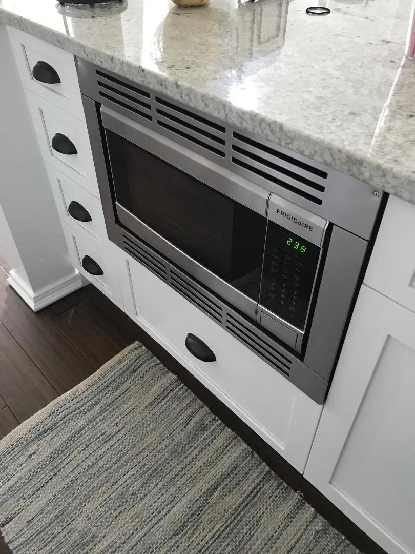 Our "built in" hidden microwave. I don't recommend Frigidaire, this is the only microwave available that fit our space. It broke a month after we moved in and it took Frigidaire almost 2 months to replace it. Needless to say, I'm not a fan of theirs.