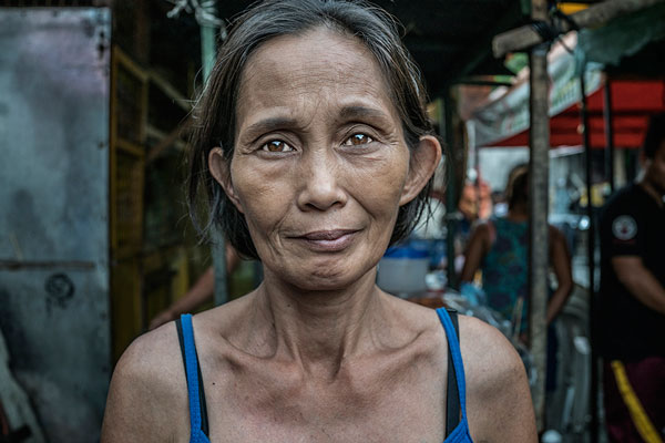  Portrait of Lucia Abletes, mother of Junnar Abletes, 27, who was gunned down in Duterte's "War on Drugs" when he returned for a family visit from the island of Samar. Lucia did not believe it was safe for him to be in Market 3 slum, even though he h
