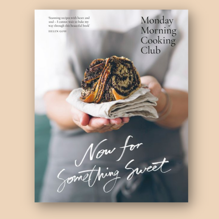 Cover of a cookbook titled "Now for Something Sweet" by the Monday Morning Cooking Club, featuring a person holding a chocolate swirl pastry wrapped in a cloth.