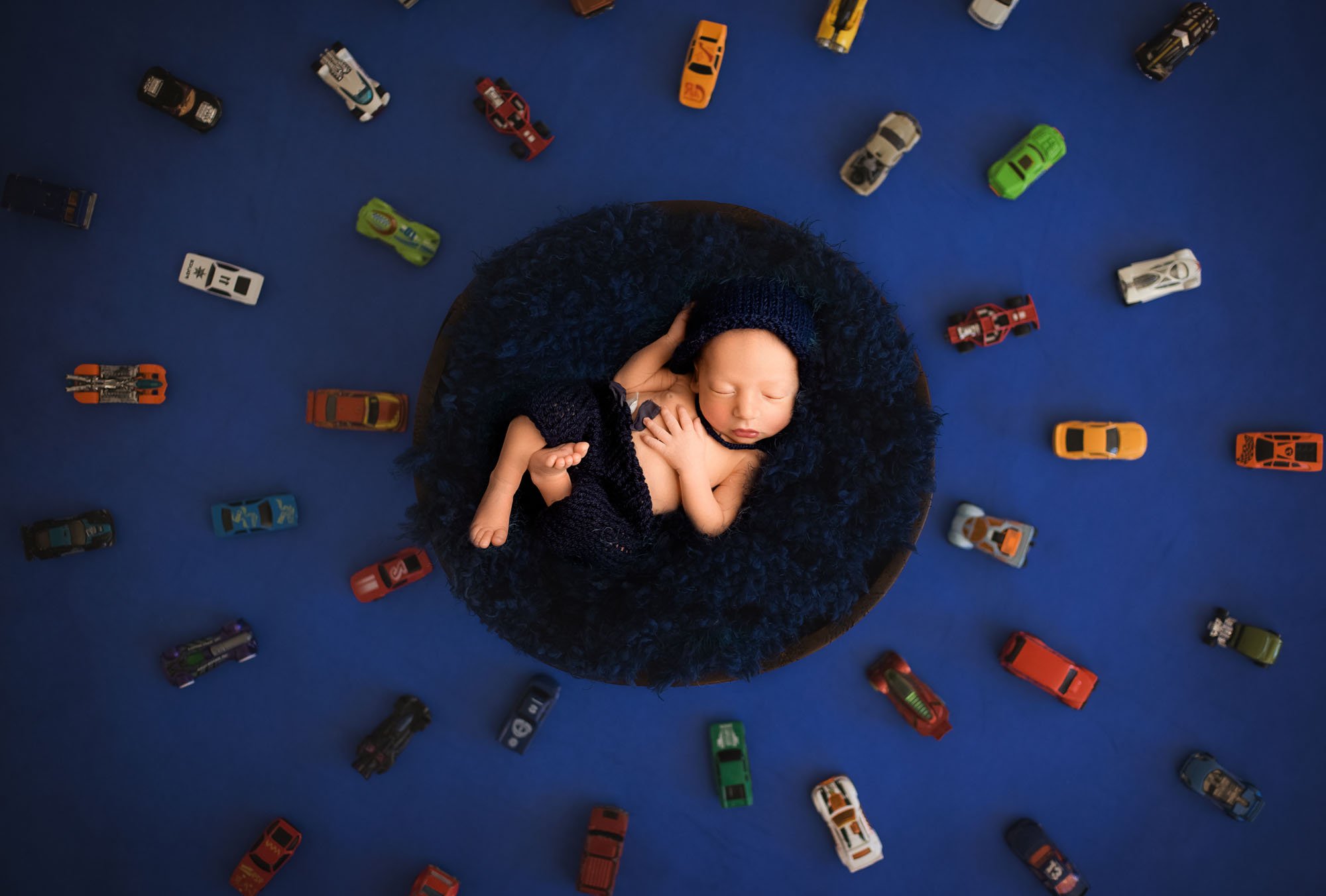 Newborn-photography-in-leeds-baby-boy-with-cars.jpg