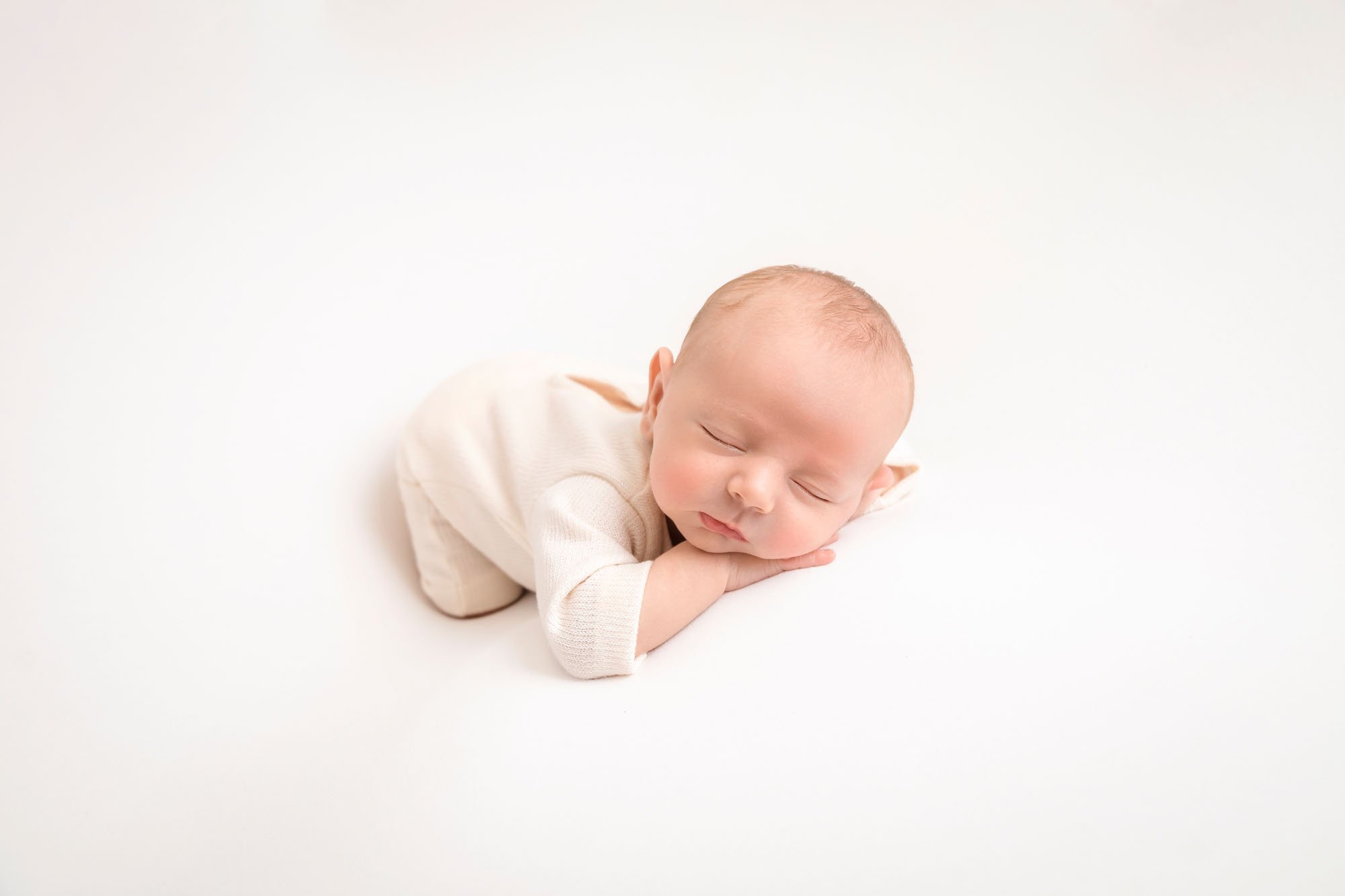 Newborn-photography-in-leeds-baby-on-white-front-facing.jpg