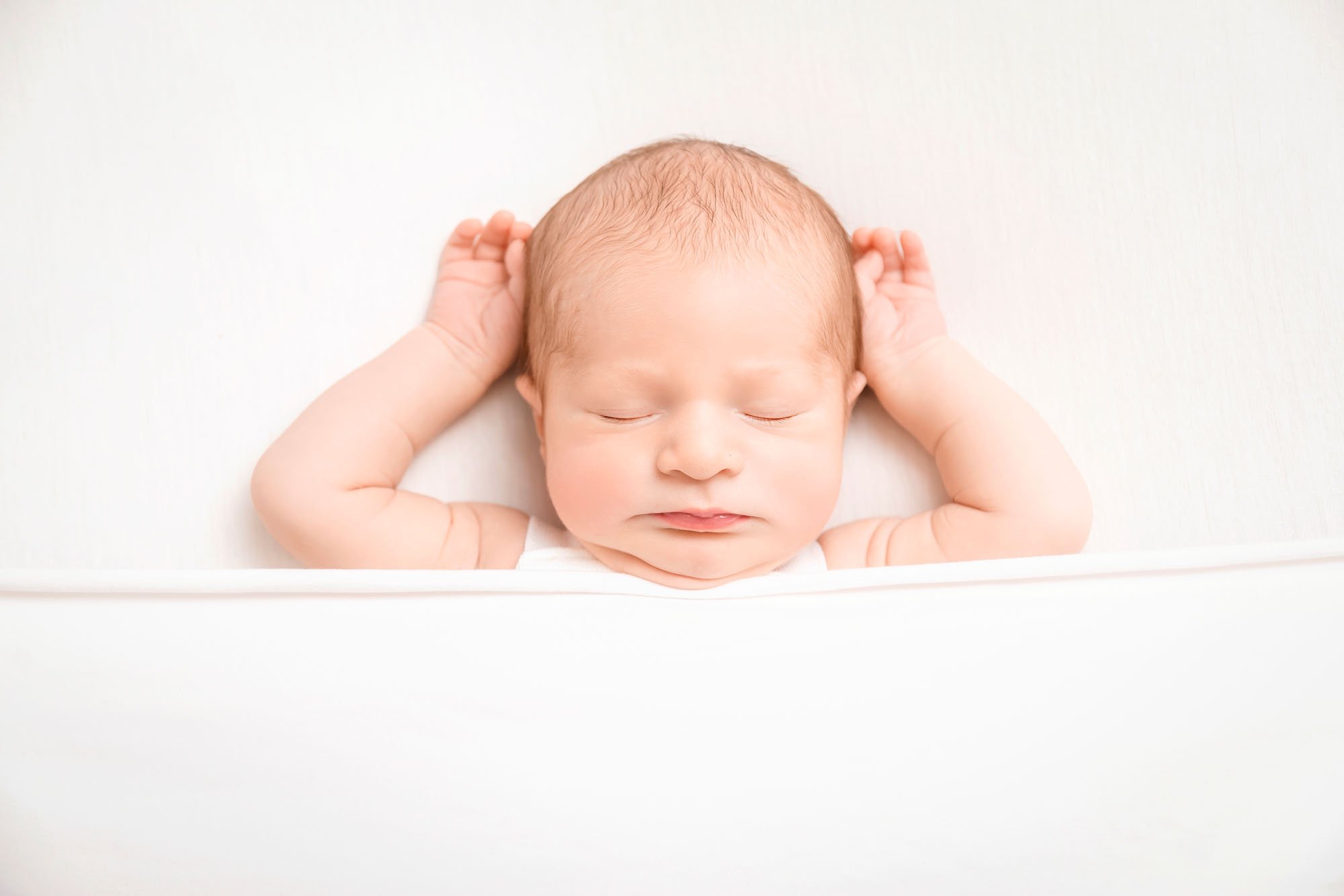 Newborn-photography-in-leeds-tucked-in-bed-white.jpg