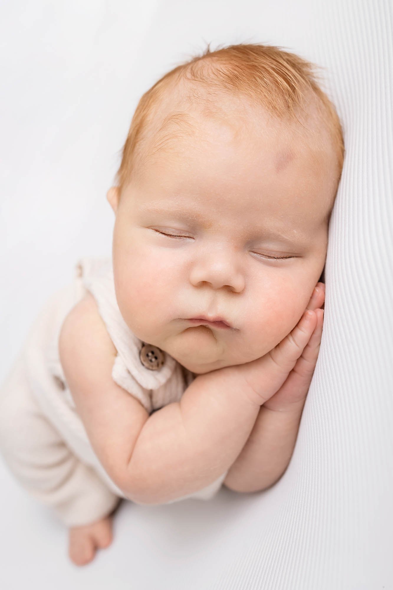 Newborn_photography_in_Leeds_baby_boy_on_white_sleeping.jpg