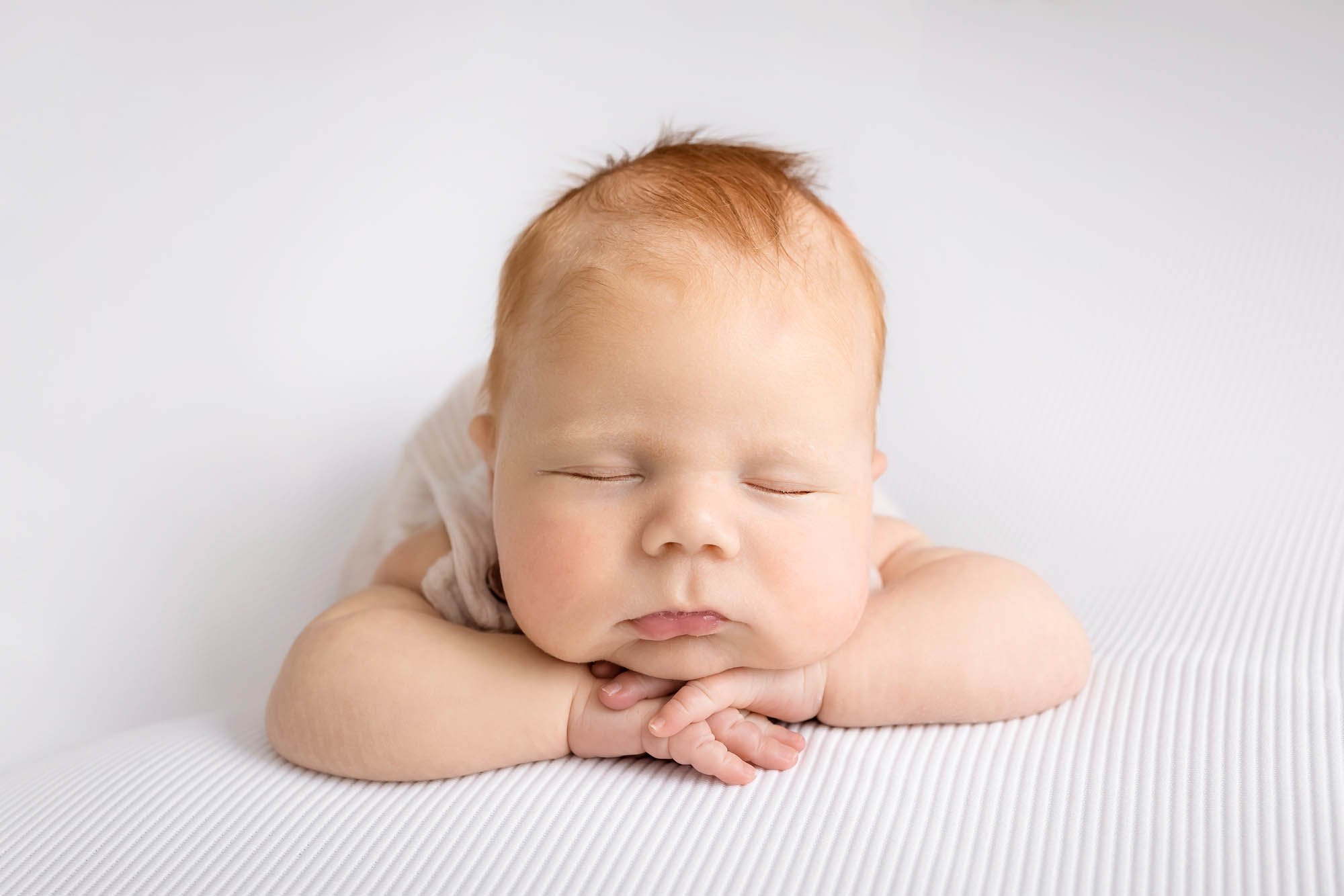 Newborn_photography_in_Leeds_baby_boy_on_white_front_facing.jpg