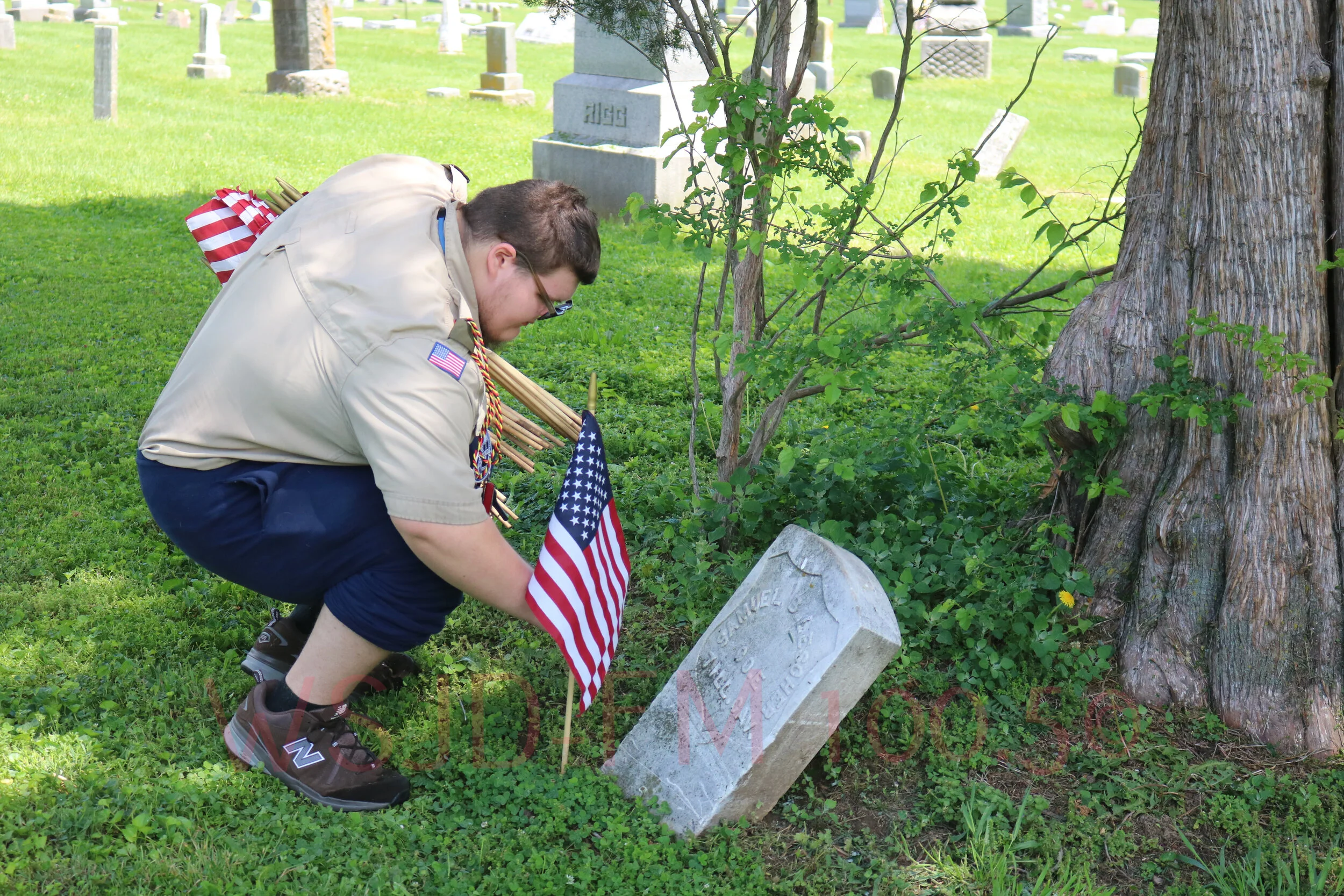 Scouts And Volunteers Busy Placing Flags On Veterans Graves