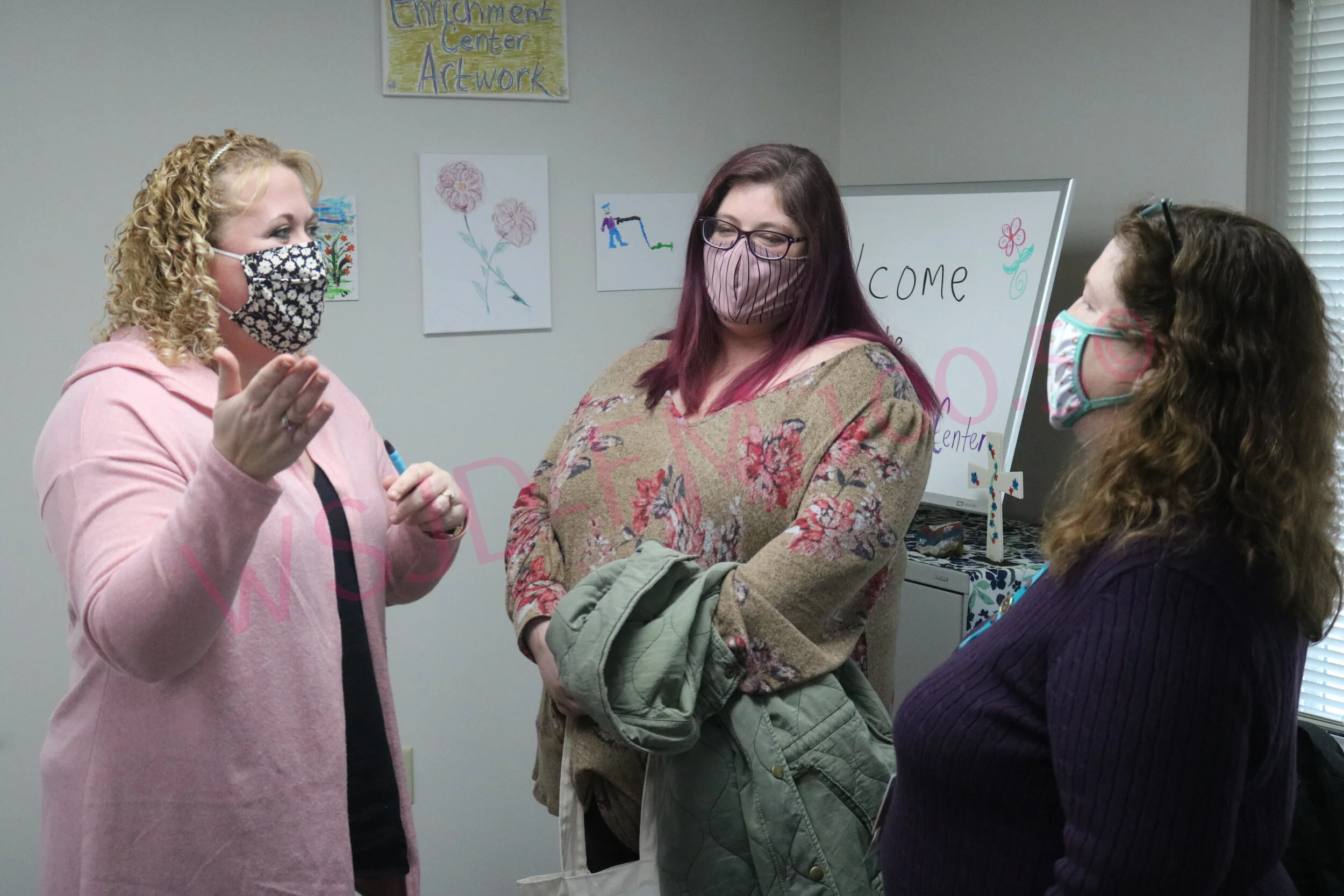New Chamber of Commerce administrative assistant Lori Cotner (Center) listens as Chamber  executive director Lesley Hipsher (L) talks with WGH’s Bridget Shepard at Monday’s ribbon cutting of the hospital’s senior enrichment center.