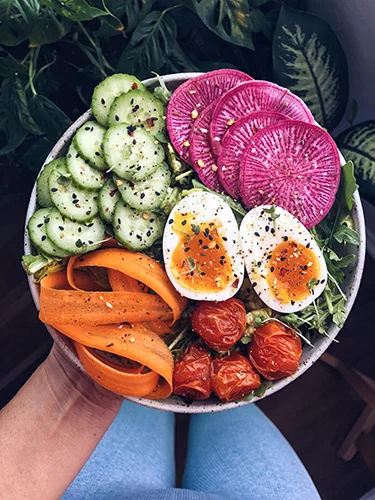 Here’s an example of one of my go-to breakfast salads. Tons of greens, veggies and soft boiled eggs. I dress all of my greens in avocado oil, lemon juice, salt and pepper. I also like to top my bowl with sesame seeds, salt, pepper and chili flakes.
