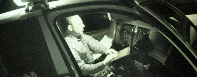 Officer in vehicle working on computer.jpg