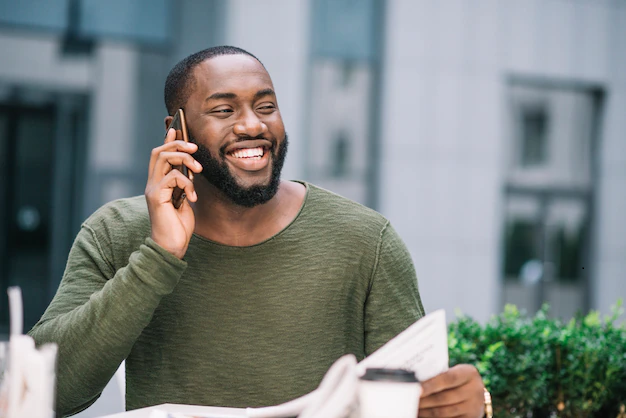 happy-man-speaking-phone-cafe_23-2147694313.png