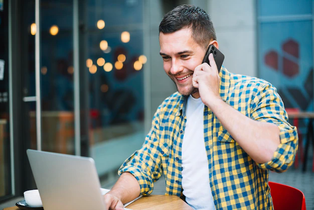 man-talking-phone-while-working-his-laptop_23-2148638124.png