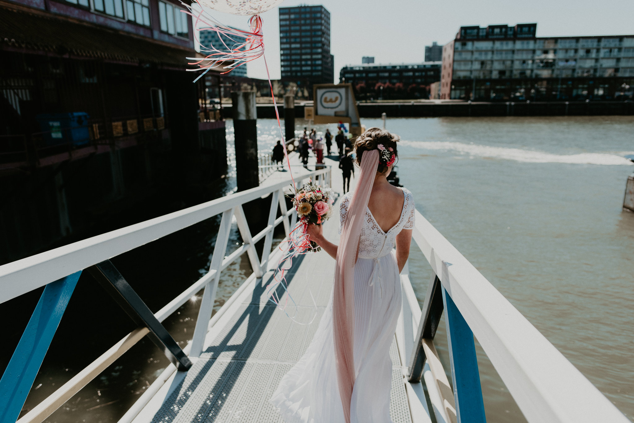 Bride walking to the Rotterdam water taxi on her wedding day