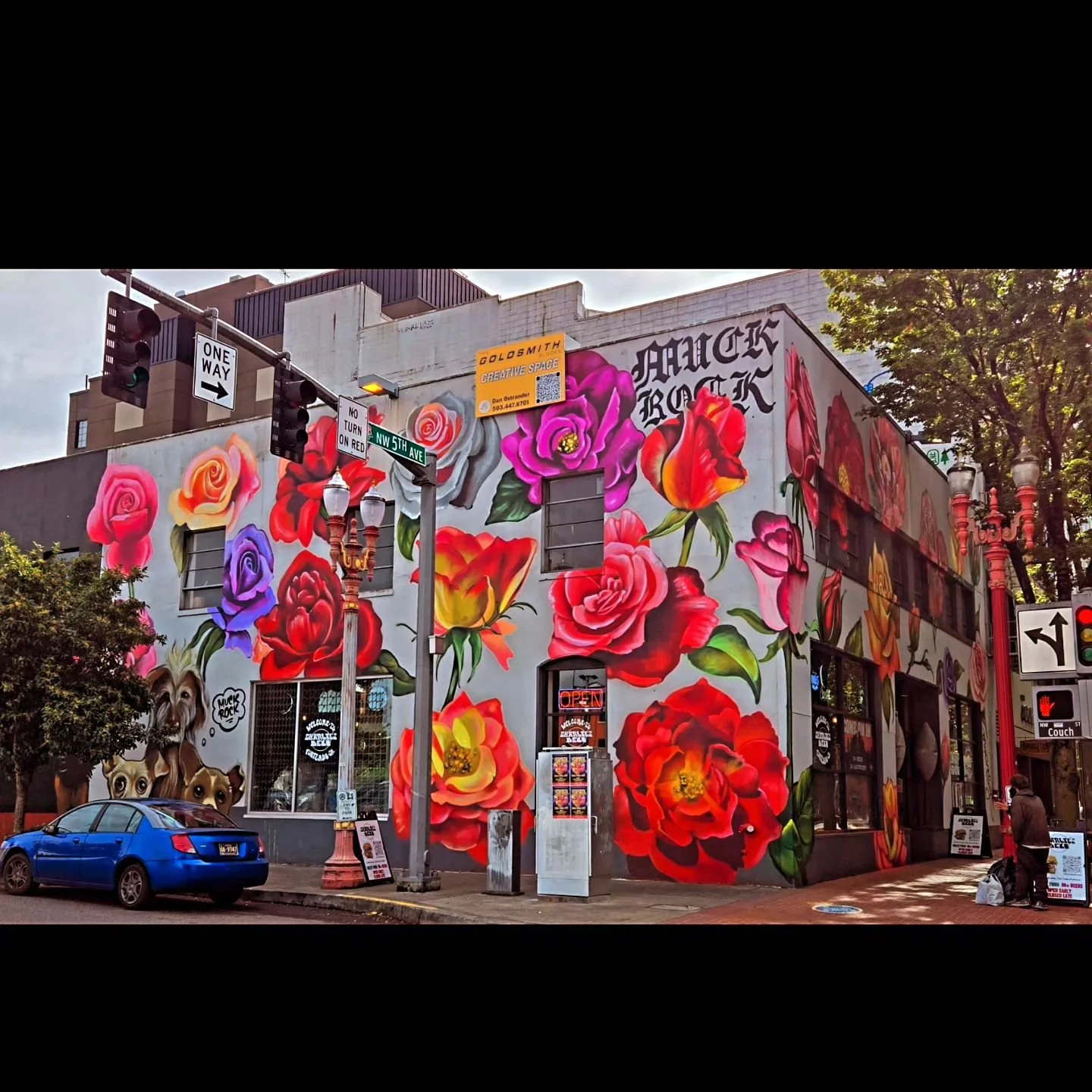 The colorful floral mural outside Charlie’s Deli