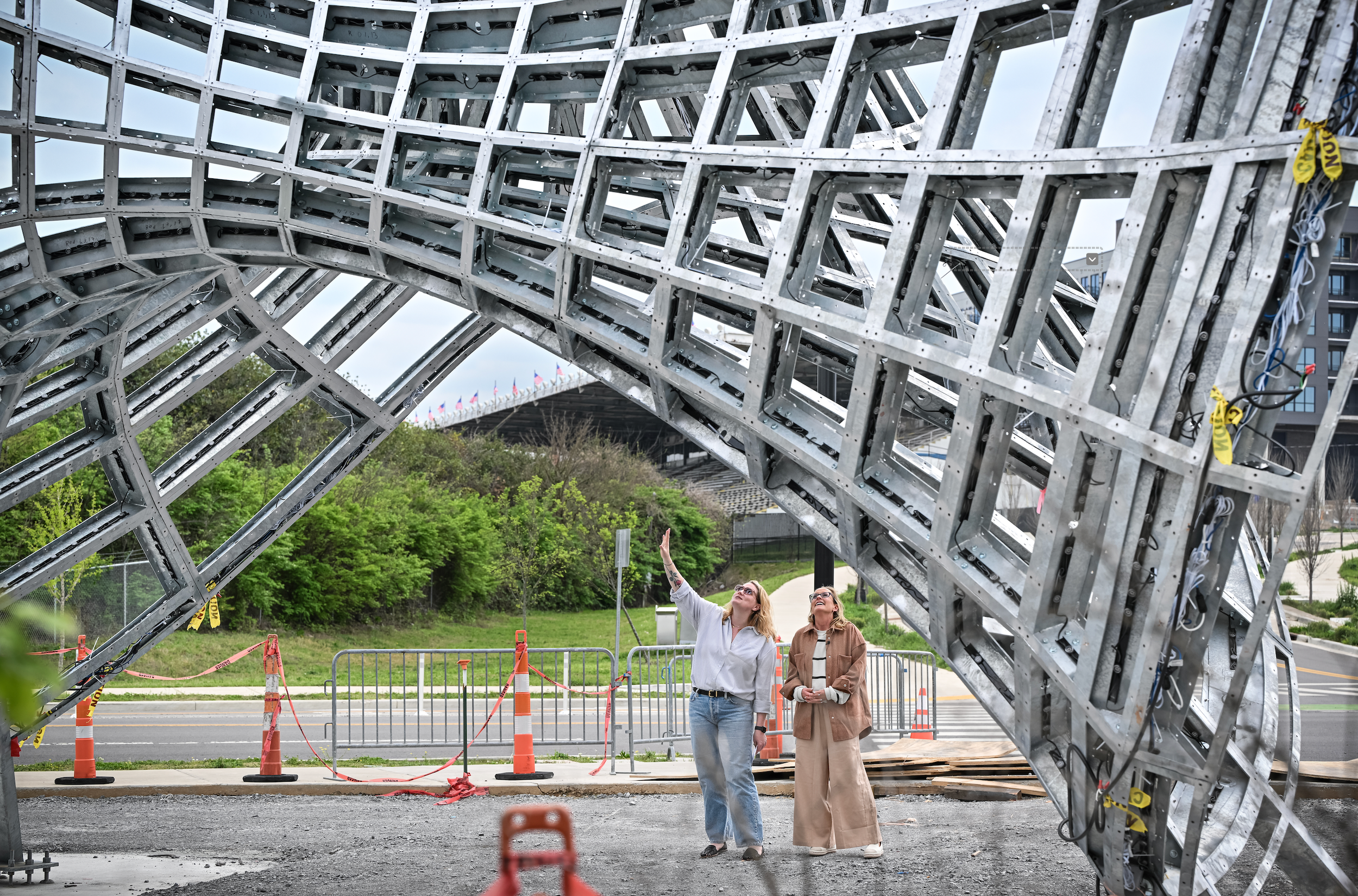 Daryn Jackson and sculptural artist Blessing Hancock examine a monumental structure from beneath