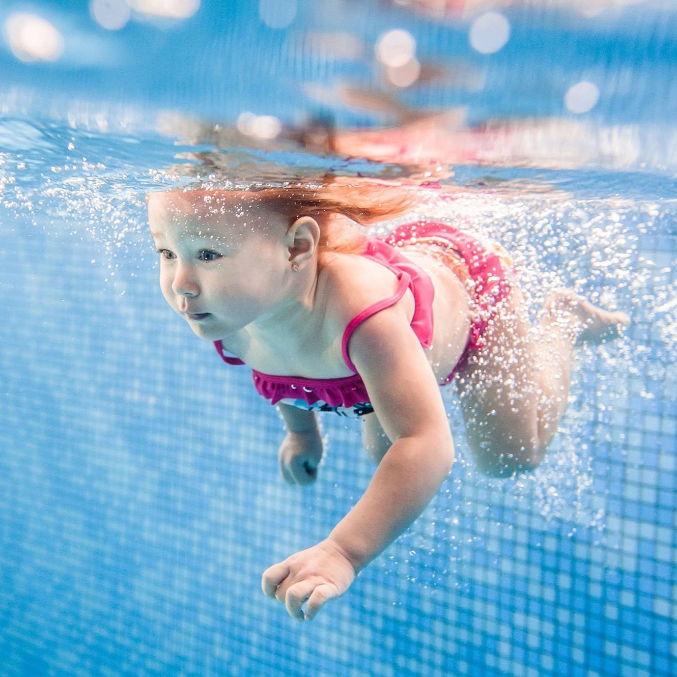 little-baby-girl-swimming-under-water-in-paddling.jpg