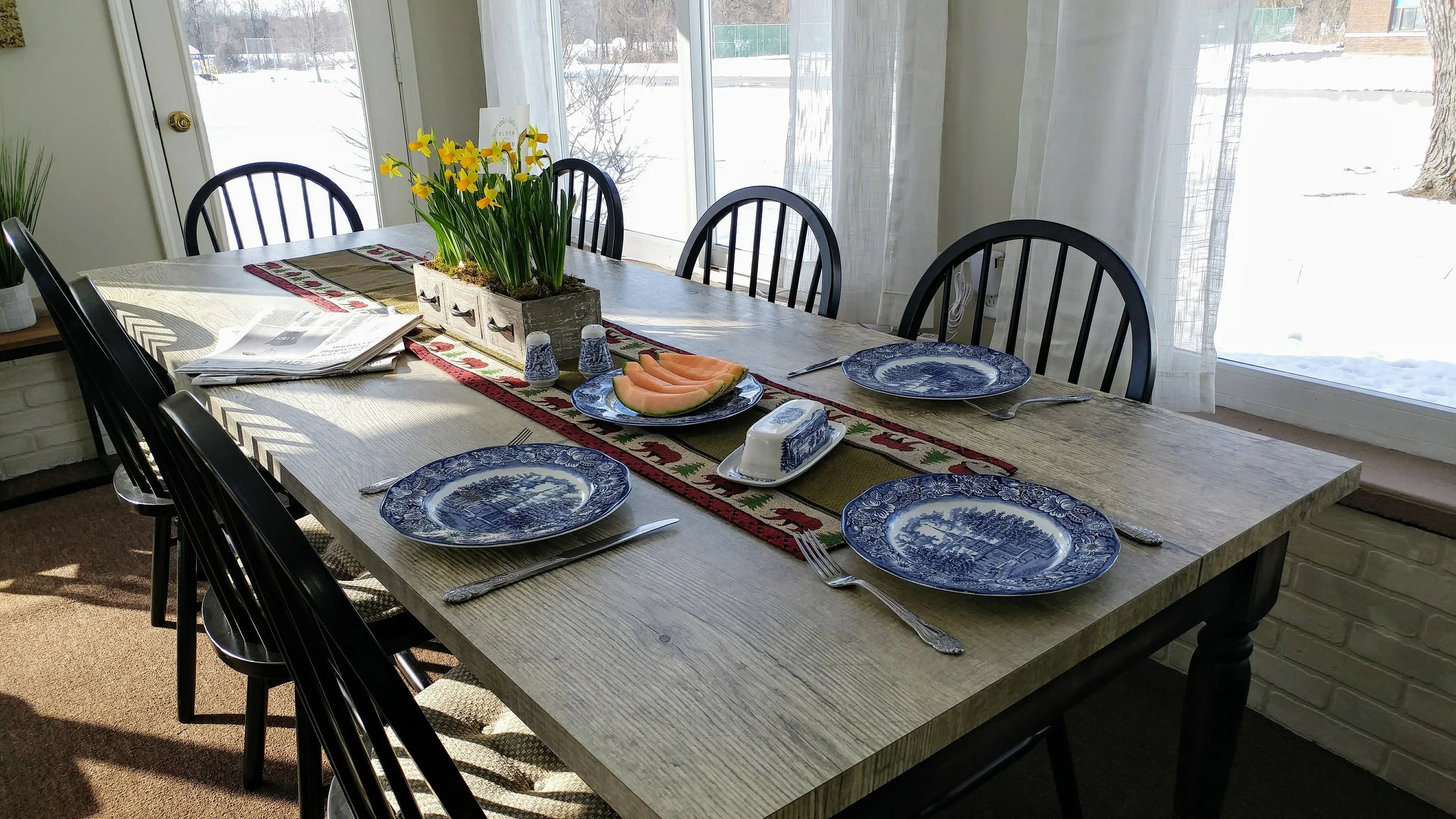 AFTER: This rustic farmhouse table was handmade for this room by a very talented craftsman. It quickly and, deservedly, becomes the focal point that instantly brings this space to a whole new level.