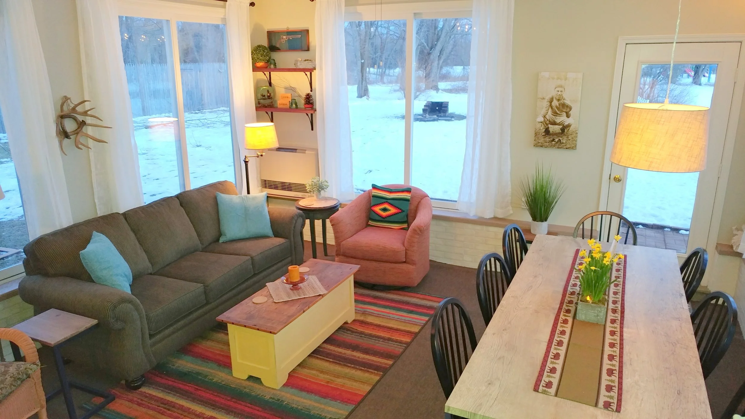 AFTER: Fresh, sunny and quite happy. This room responded so well to a loving touch. Translucent linen curtain panels now filter the sun and soften the effects of so much glass. The room is colorful yet tranquil. Coffee anyone?