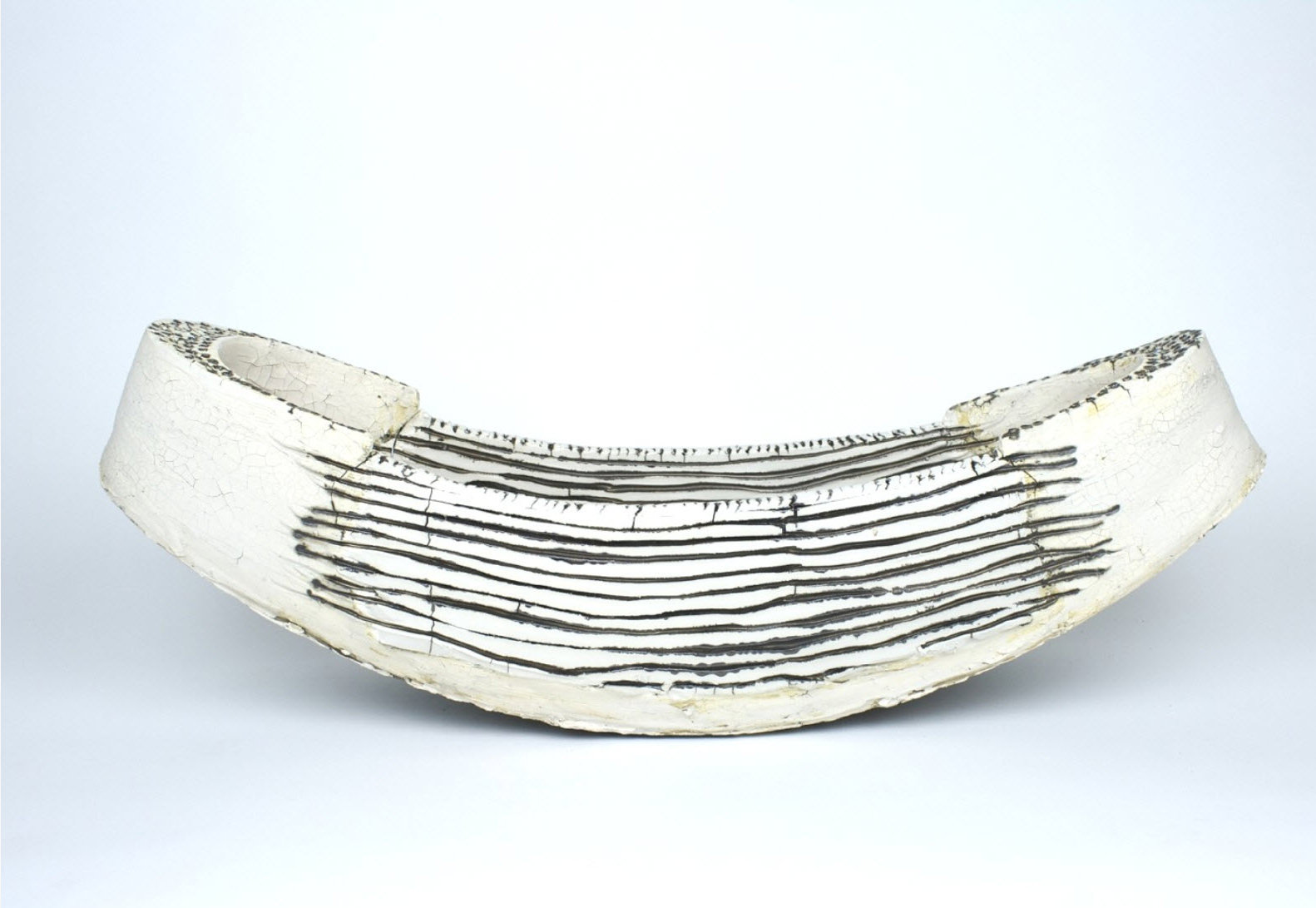 “Black and White Boat Form with Black Lines,” stoneware and porcelain ceramic with slips, pigments and glaze, h: 8” x w: 8” x l: 22”