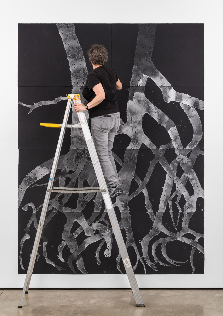 Irvine preparing a work that spans two walls at the Facebook building in downtown Austin.