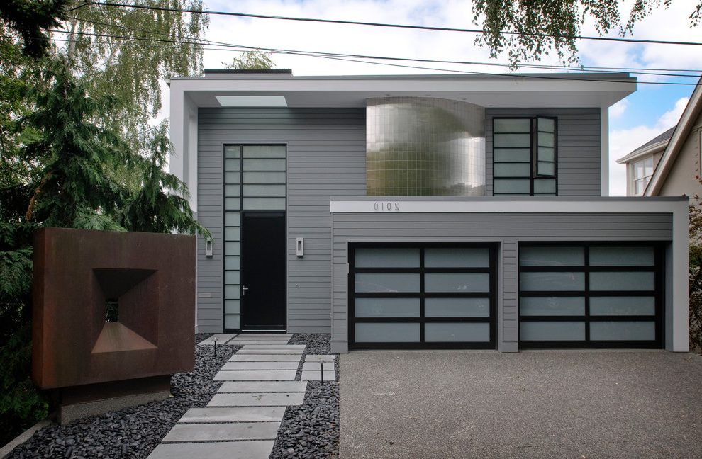 Gray-and-black-exterior-contemporary-with-translucent-glass-garage-door-house-numbers-copper-sculpture.jpg