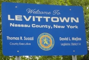 Levittown, named after its builder Levitt & Sons, Inc., was developed between 1947 and 1951 with backing from the Federal Housing Administration. This first and largest mass-produced suburb prohibited lease or sales to non-white residents.