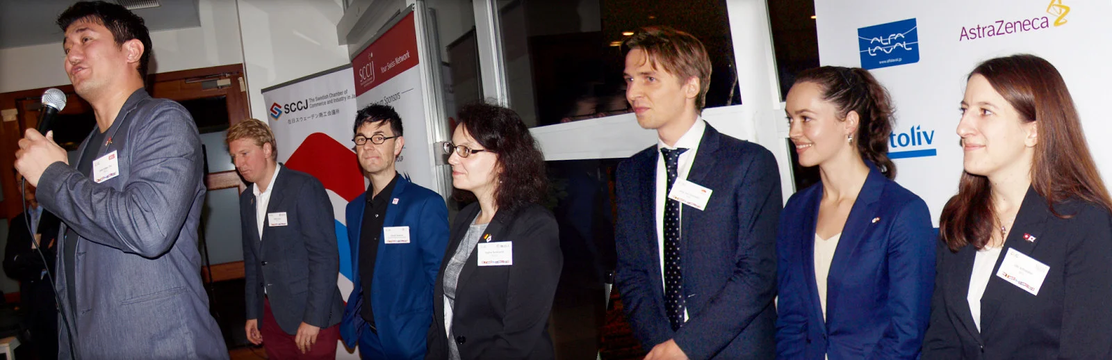 Representatives of the CLIC Chambers introduce themselves; on stage Leon Esben Ota (DCCJ), behind from left: Marin Koos (SCCJ), Arnold Ackerer (ABC), Sophie Bocklandt (BLCCJ), Jorg van Leeuwen (NeCCJ), Anette Yamamoto-Hansen (NCCJ) and Lilo Schneider (SCCIJ). The last, Clas Bystedt (FCCJ) behind the camera.