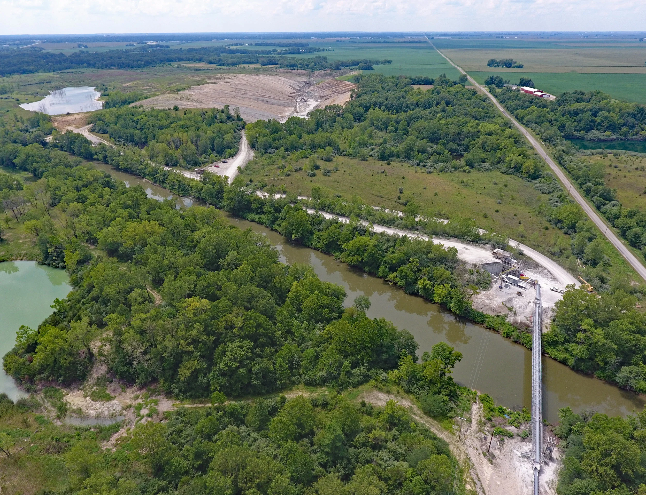Overview of river conveyor, portable plant site, and west pit. June 2017. 