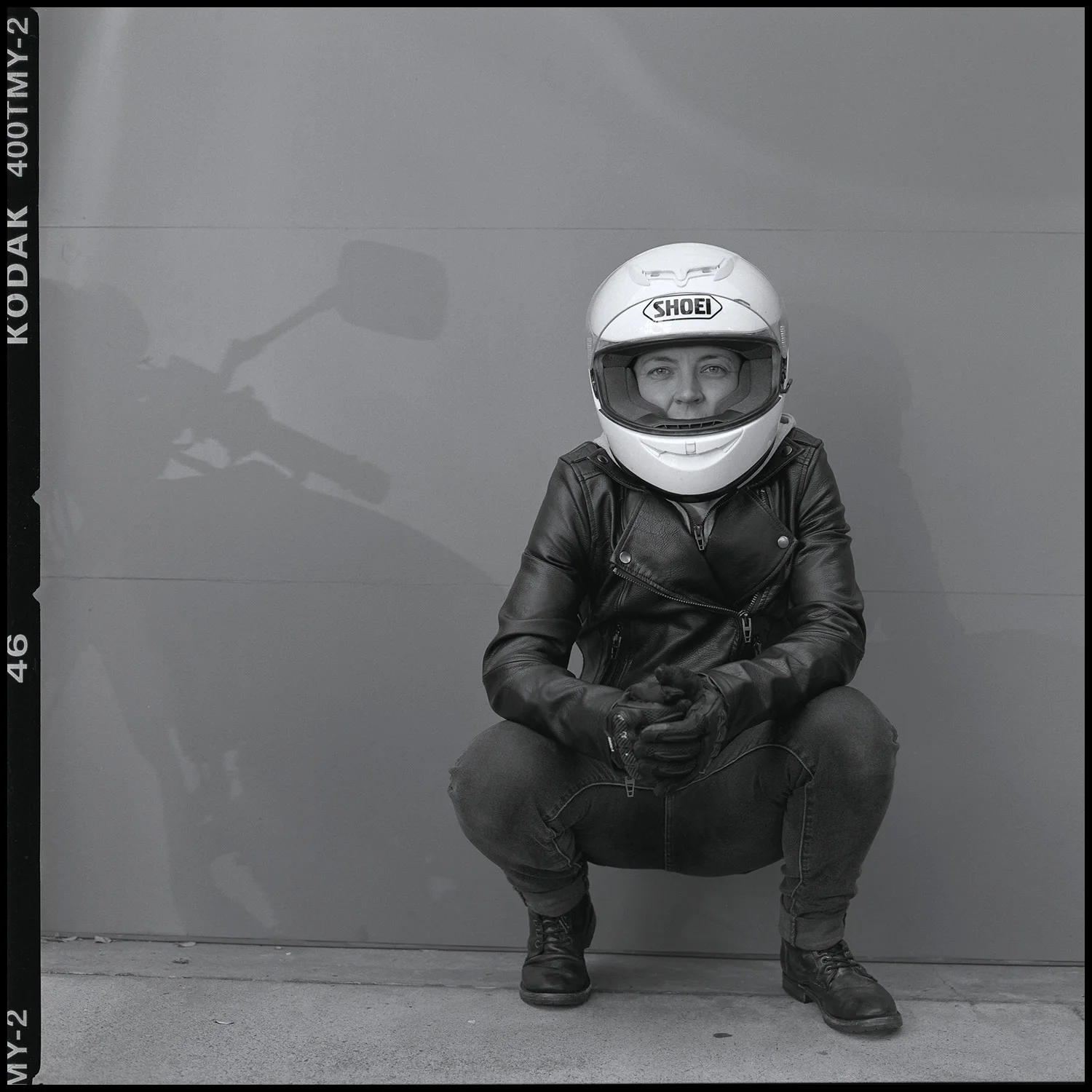 Eva Poses with the Shadow of Their Motorcycle