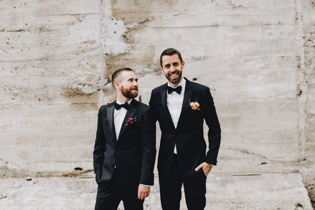Groom's pose for photo for Linden Hills Minnesota wedding, same-sex wedding planner