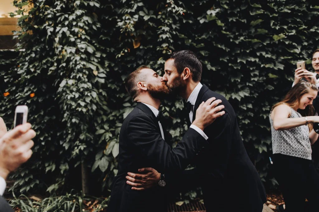 First kiss, same-sex outdoor wedding ceremony in Linden Hills Minnesota