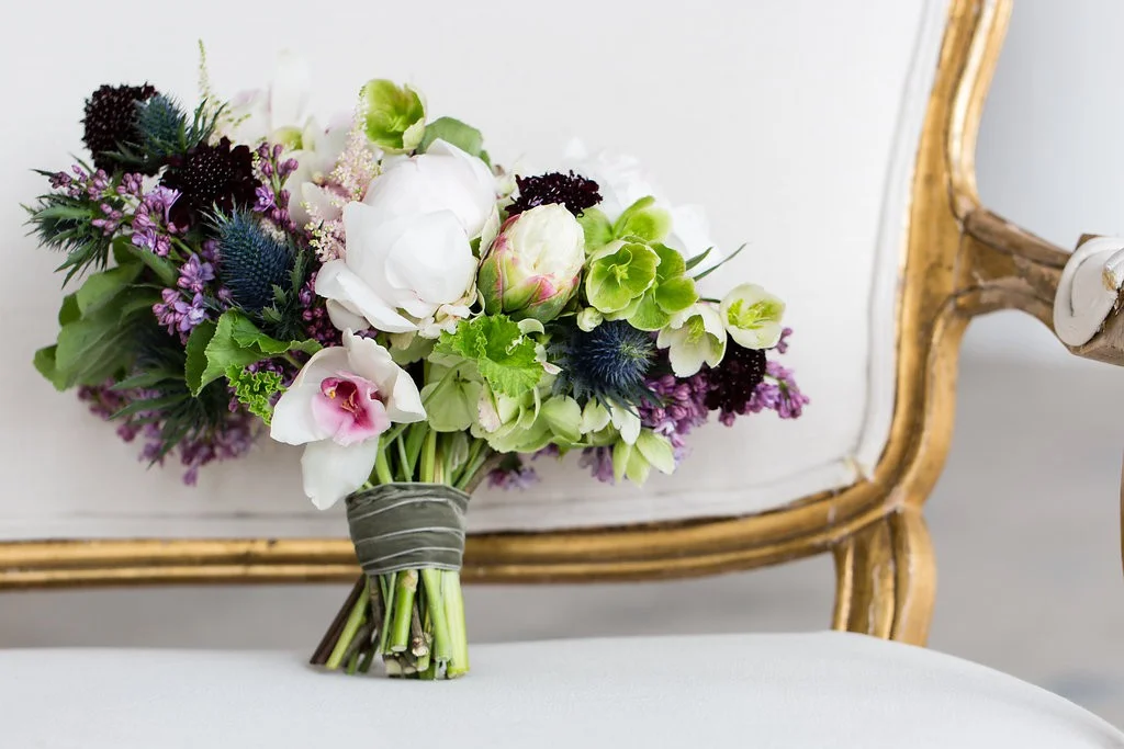 Garden style bouquet in shades of green, purple, white and deep navy blue